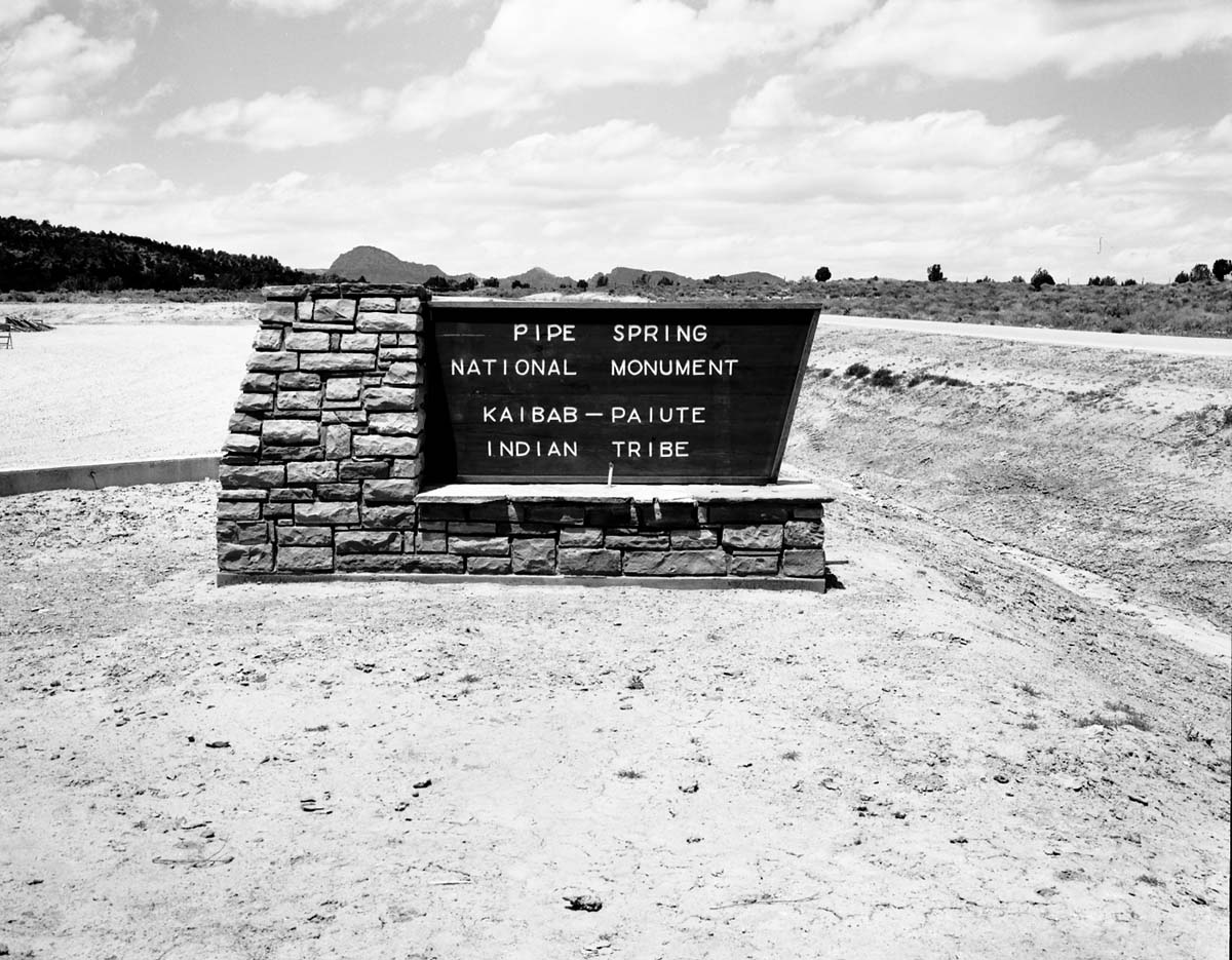 The main highway sign in front of the new Tribal and National Park Service Visitor Center at time of the dedication ceremony and the 50th anniversary celebration of Pipe Spring National Monument.