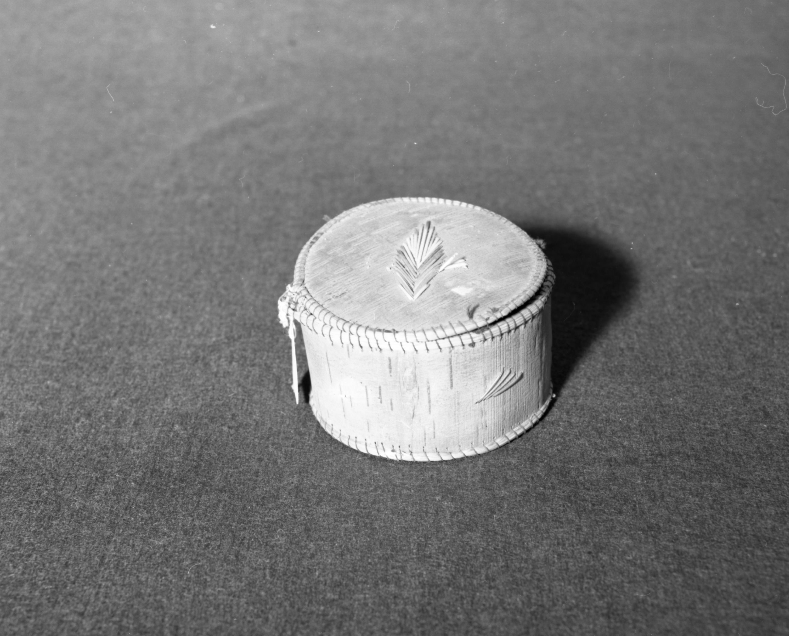 Marie Rozier Collection, Catalog No. 90. Object: Micmac (?) birchbark container. Dimensions: 4 x 2 1/4". Materials: Birchbark, sweetgrass, dyed porcupine quills. Collection History: "Brattleboro, VT" stamped on lid. Photographed by Michael Dixon in December 1982. Catalogued by Craig Bates and Barbara Beroza. Yosemite Collections, National Park Service.