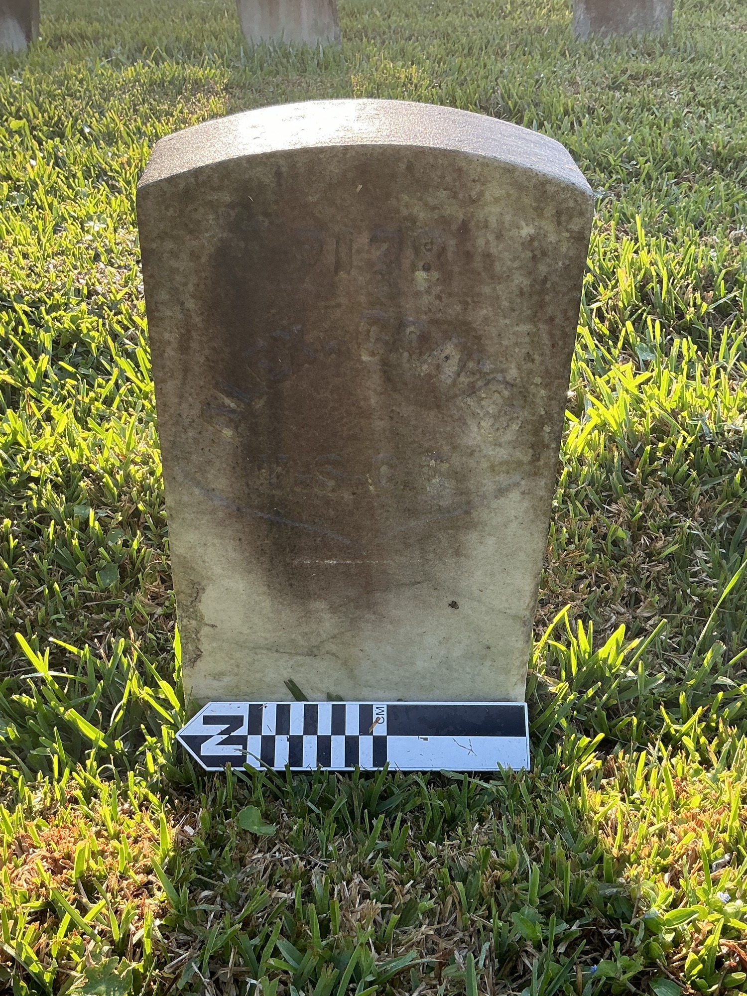 Extra image of historic upright marble headstone with recessed shield with recessed lettering face.