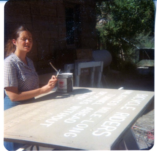 NPS personnel painting a sign.