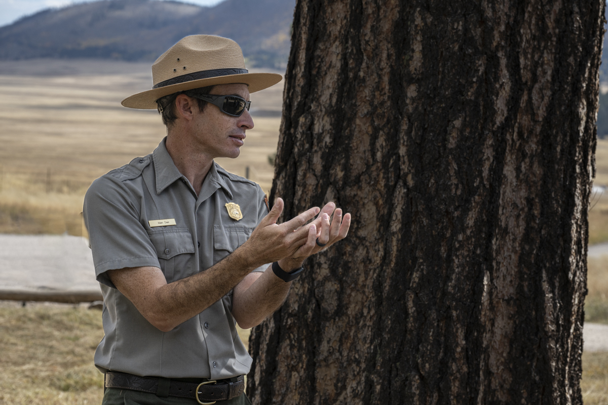 A park ranger holds up his hands during a guided hike.