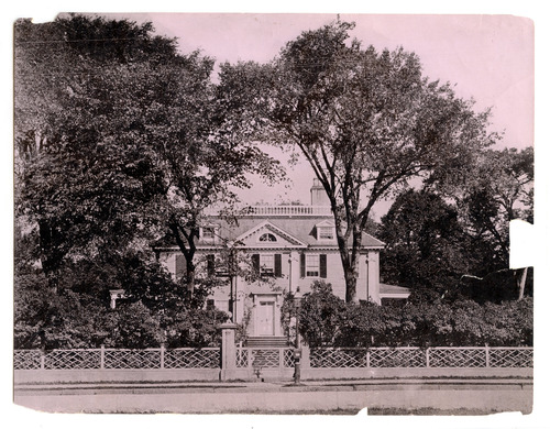 Georgian mansion from across the street framed by two tall trees