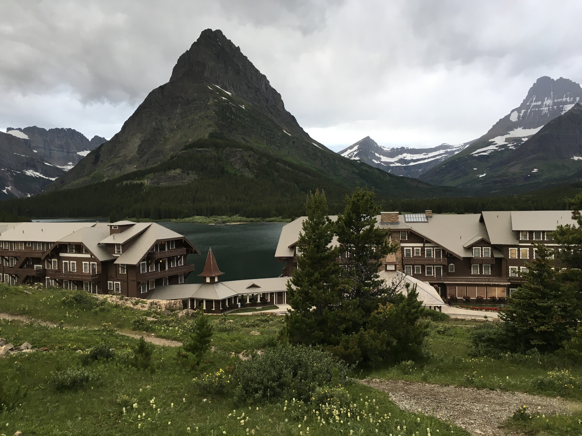Large hotel building at the base of a mountain range