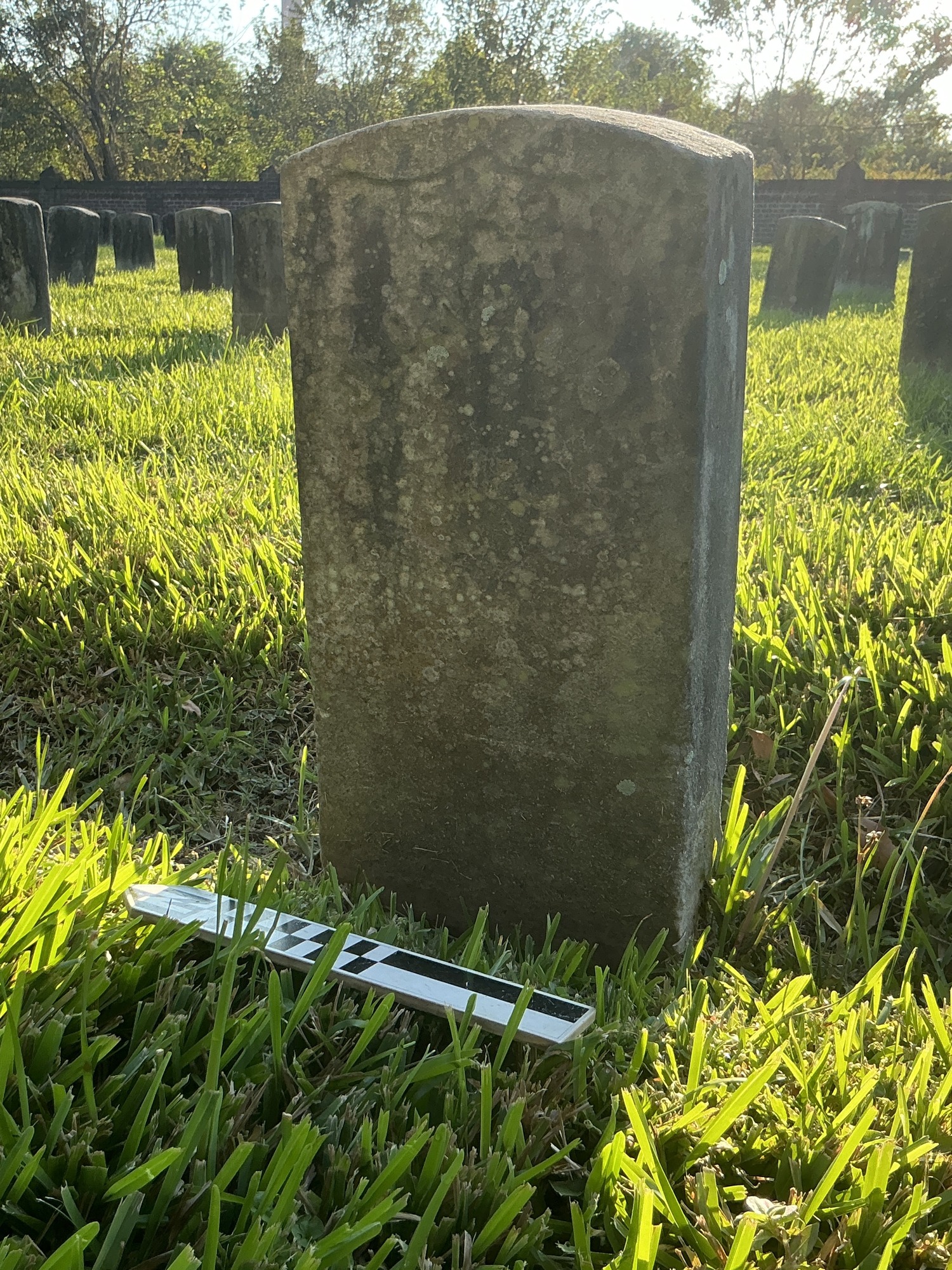 Extra image of historic upright marble headstone with recessed shield face.