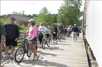 Cuyahoga Valley Scenic Railroad, Bikers Waiting to Board Train. In 2007 CVSR and NPS launched Bike Aboard!service to encourage use of the railroad as alternative transportation. For a $2 fare cyclists can ride the train in one direction and bike the other along the Ohio & Erie Canal Towpath Trail. Some images are at Rockside Station and others in Peninsula near the Peninsula Depot.