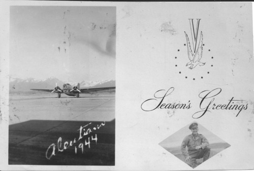 A postcard with image of an airplane on the left and text "Aleutians 1944".  On the right "Season's Grettings" and a dimond shaped photo of an officer. 