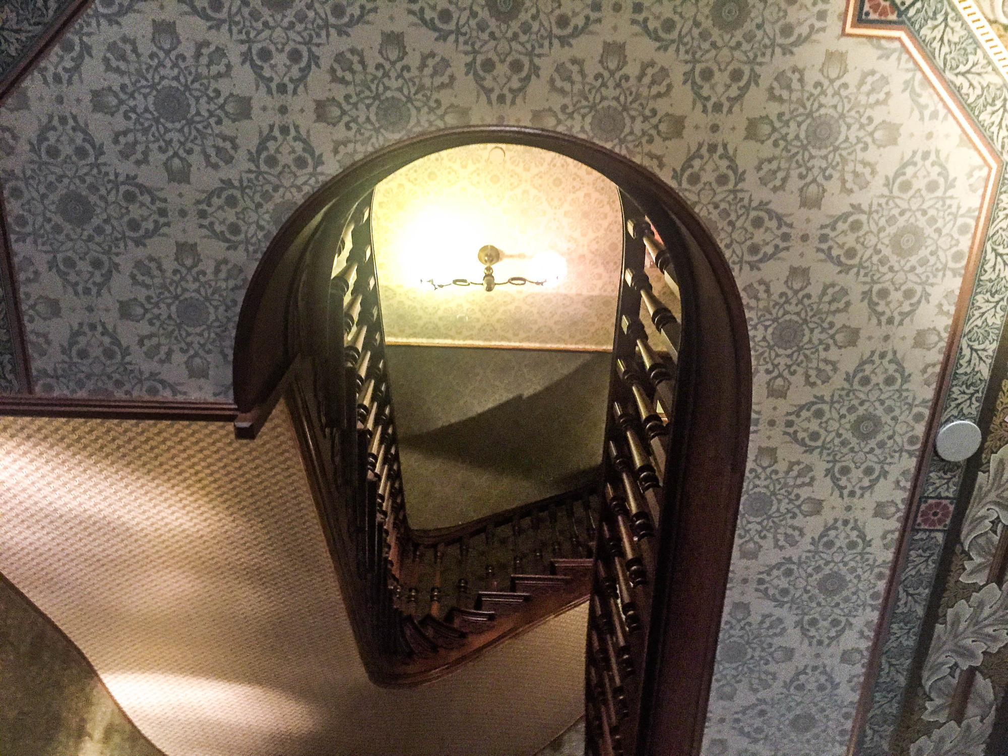 Staircase and ceiling decorated with elaborate wallpaper