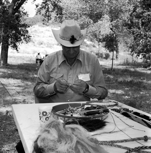Lamond Tait braids horsehair into belts, hat bands, and whips at third Folklife Festival at the Zion National Park Nature Center, September 1979.