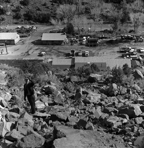 Fall which damaged the plumber shop at Oak Creek maintenance area on March 9, 1978. R.D. Pollock stands on the hill side (south) viewing damage from above.