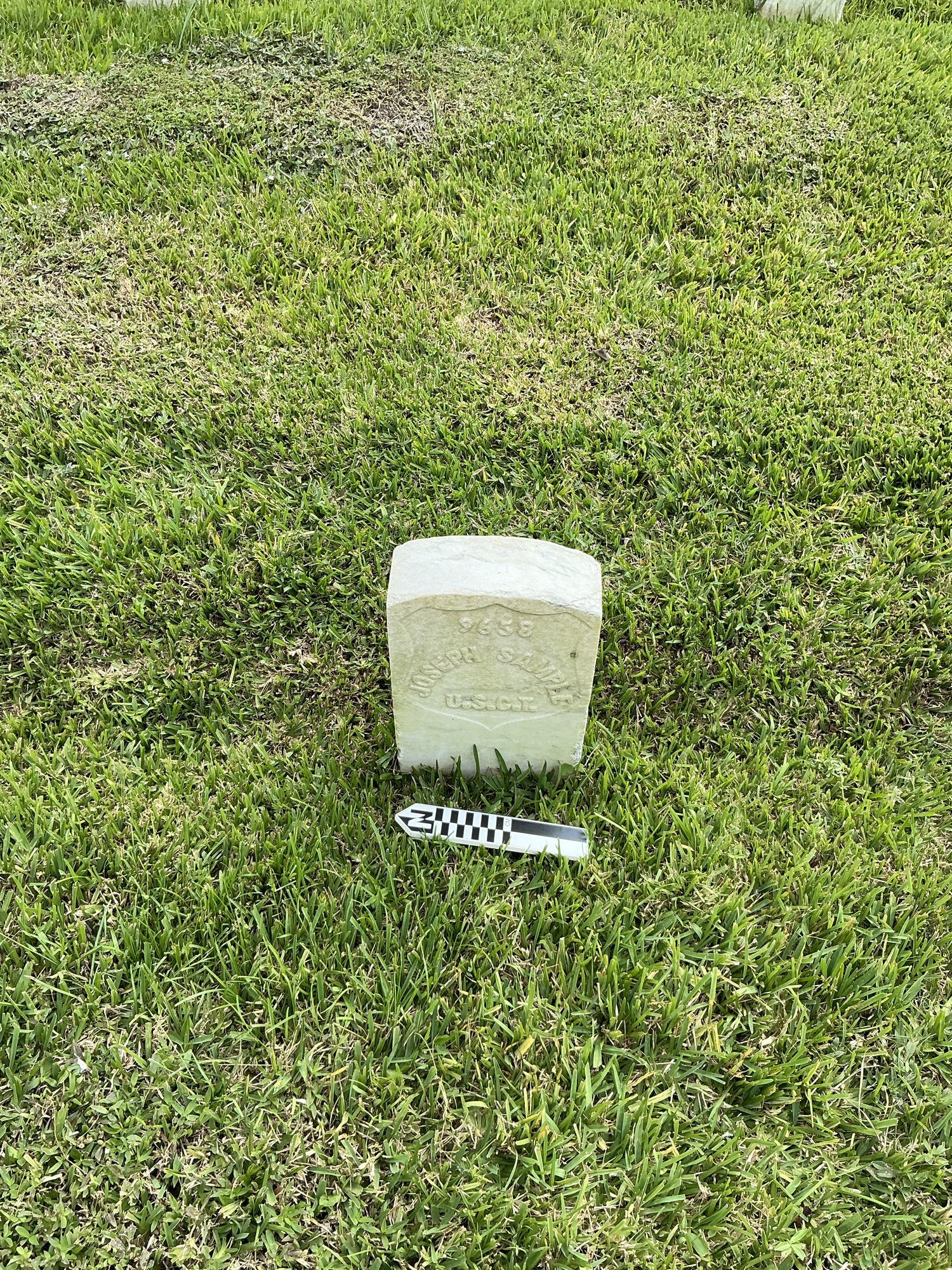 Extra image of historic upright marble headstone with recessed shield face.