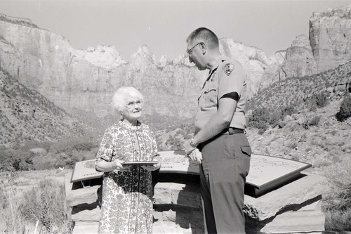 BW Photos of Superintendent Harold Grafe giving award to lady.