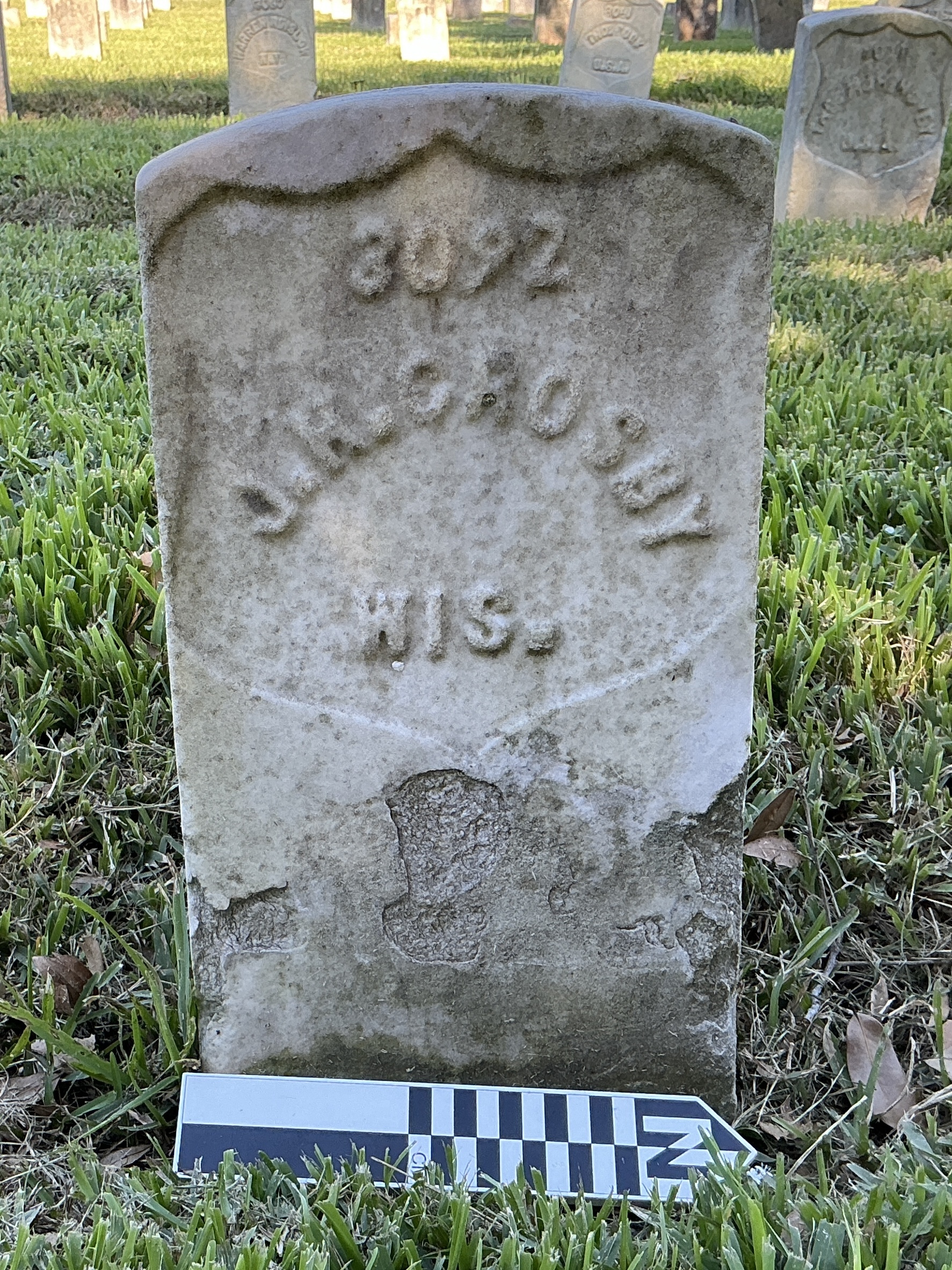 Extra image of historic upright marble headstone with recessed shield face.
