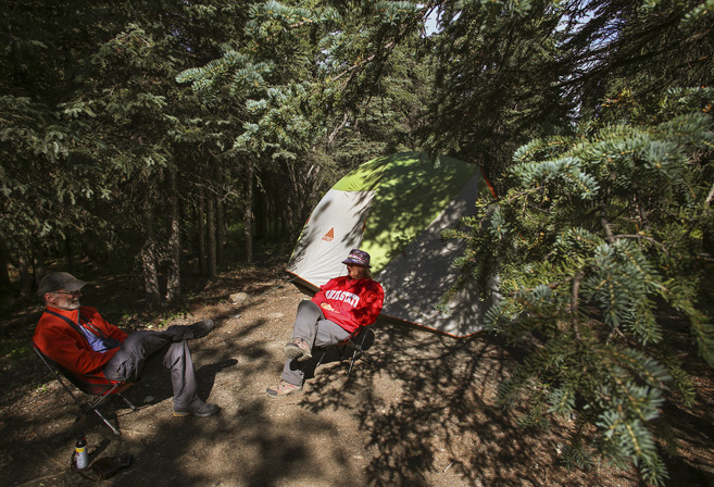 two people sitting outside a tent