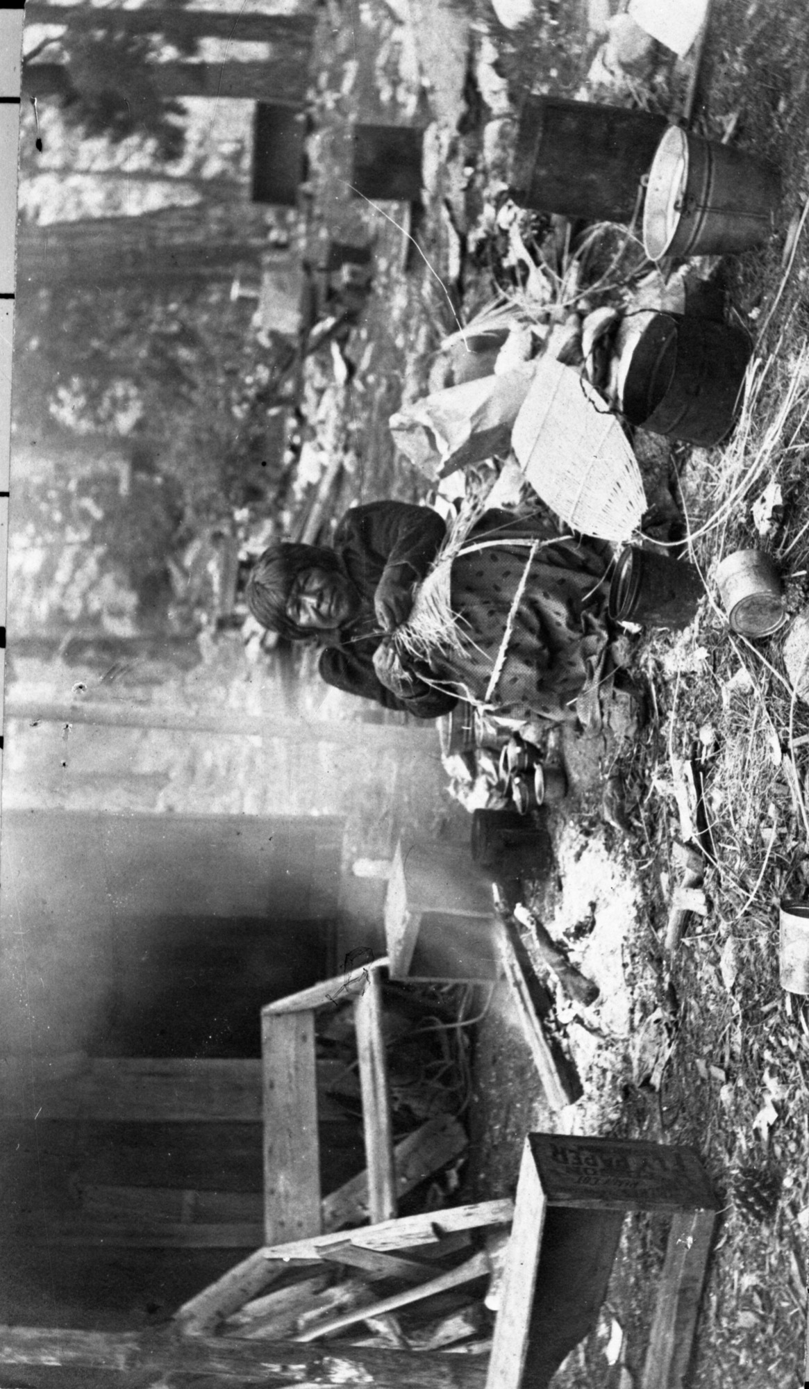 Indian Mary. Note the unfinished cradleboard hood in her lap and the finished back board to her left.
