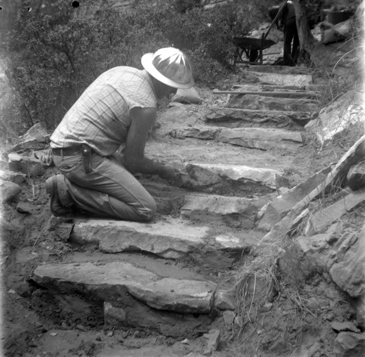 Man working on the reconstruction of the Emerald Pool trail. [See also Series 008.07.02 - The installation of a handrail on the Weeping Rock trail.]