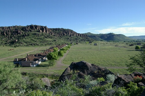 view from above of a line of buildings beside an open field