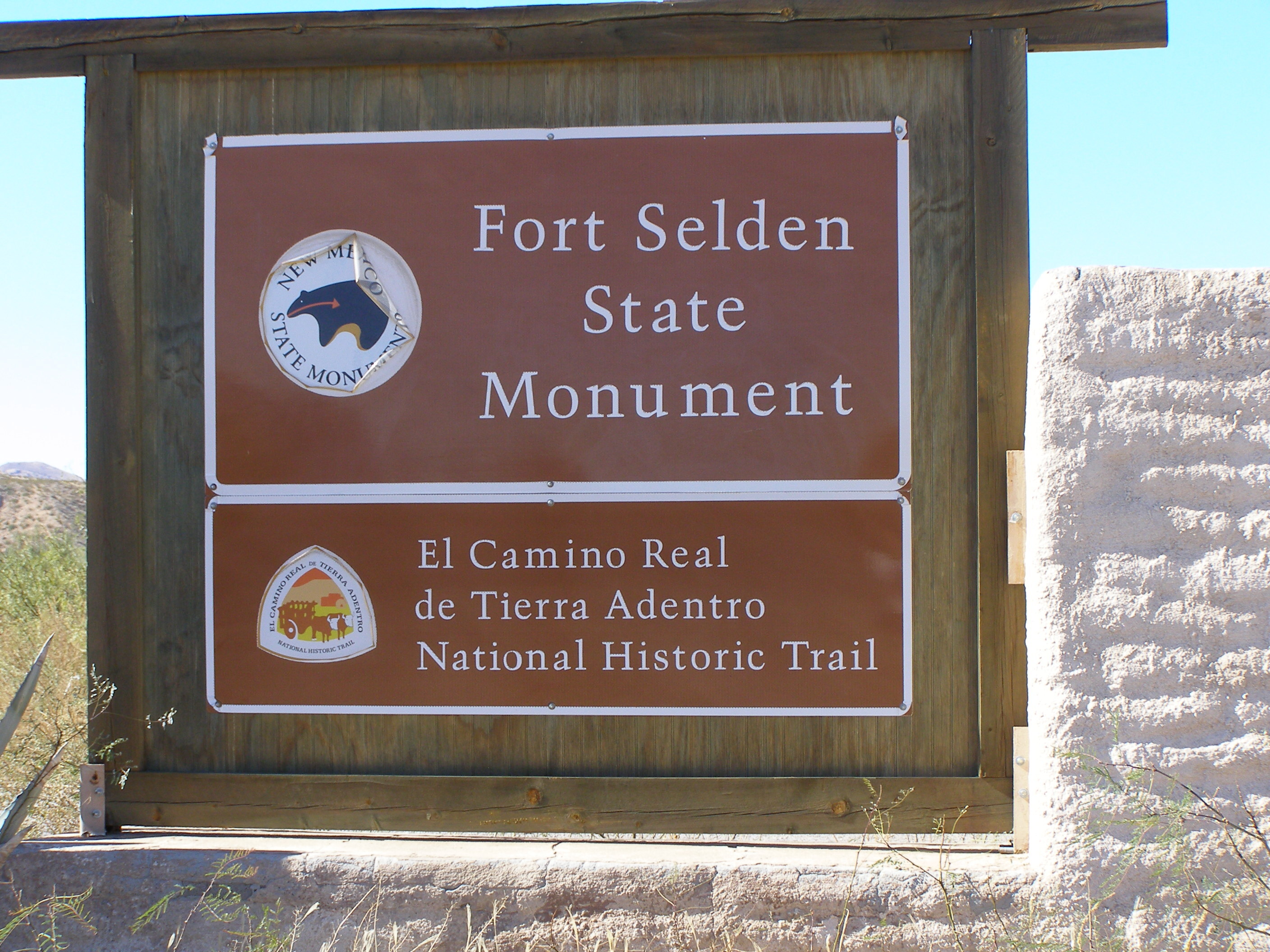 A sign with the text "fort selden state monument" on it.