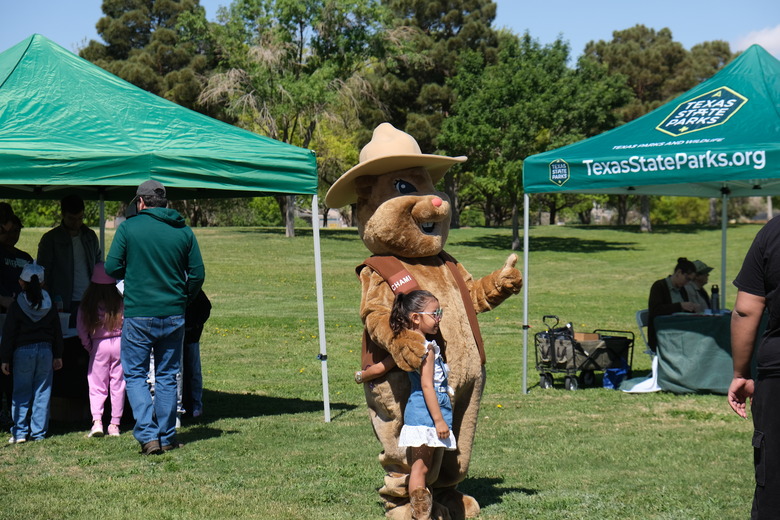 Park mascot Chami poses for a photo with a Junior Ranger.