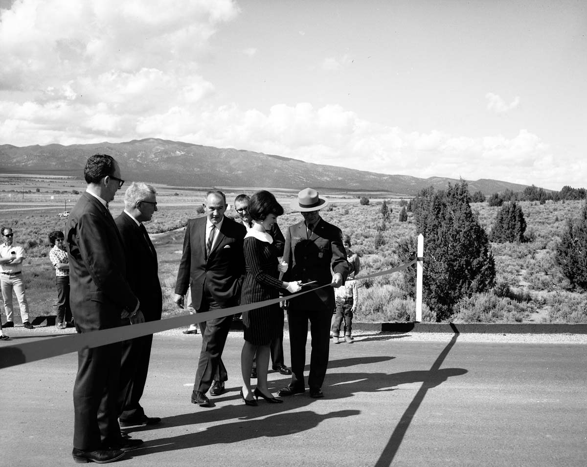 Park Superintendent Warren F. Hamilton and Jana Jackson, 1967 Queen of Washington County, cutting ribbon during dedication of Taylor Creek road (Kolob Canyons). Left to right: Springdale Mayor Fotheringham, Cedar City Mayor Loren Whetten, V. Smith of the Utah Highway Department, Ms. Jana Jackson, Superintendent Warren F. Hamilton.