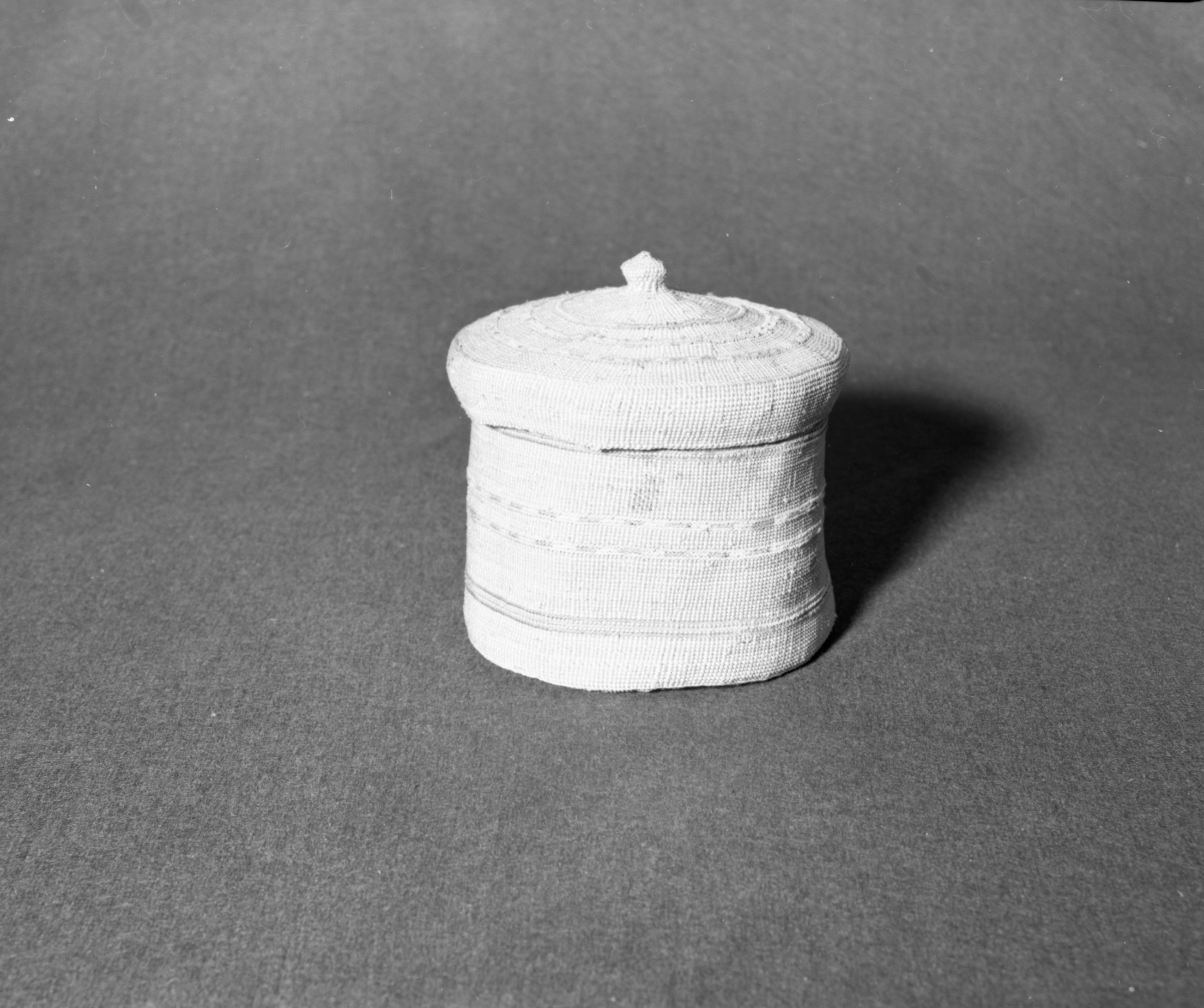 Marie Rozier Collection, Catalog No. 5-5. Object: Aleut basket. Dimensions: 7" x 7". Materials: seagrass, yarn, commercial cotton cordage. Technology: down to right slant of turns. Collection History: Gift of Flora Hill McCullough. Photographed by Michael Dixon, December 1982. Catalogued by Craig Bates and Barbara Beroza. Yosemite Collections, National Park Service.