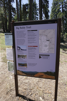A blue metal panel with a map sits in a rustic metal frame