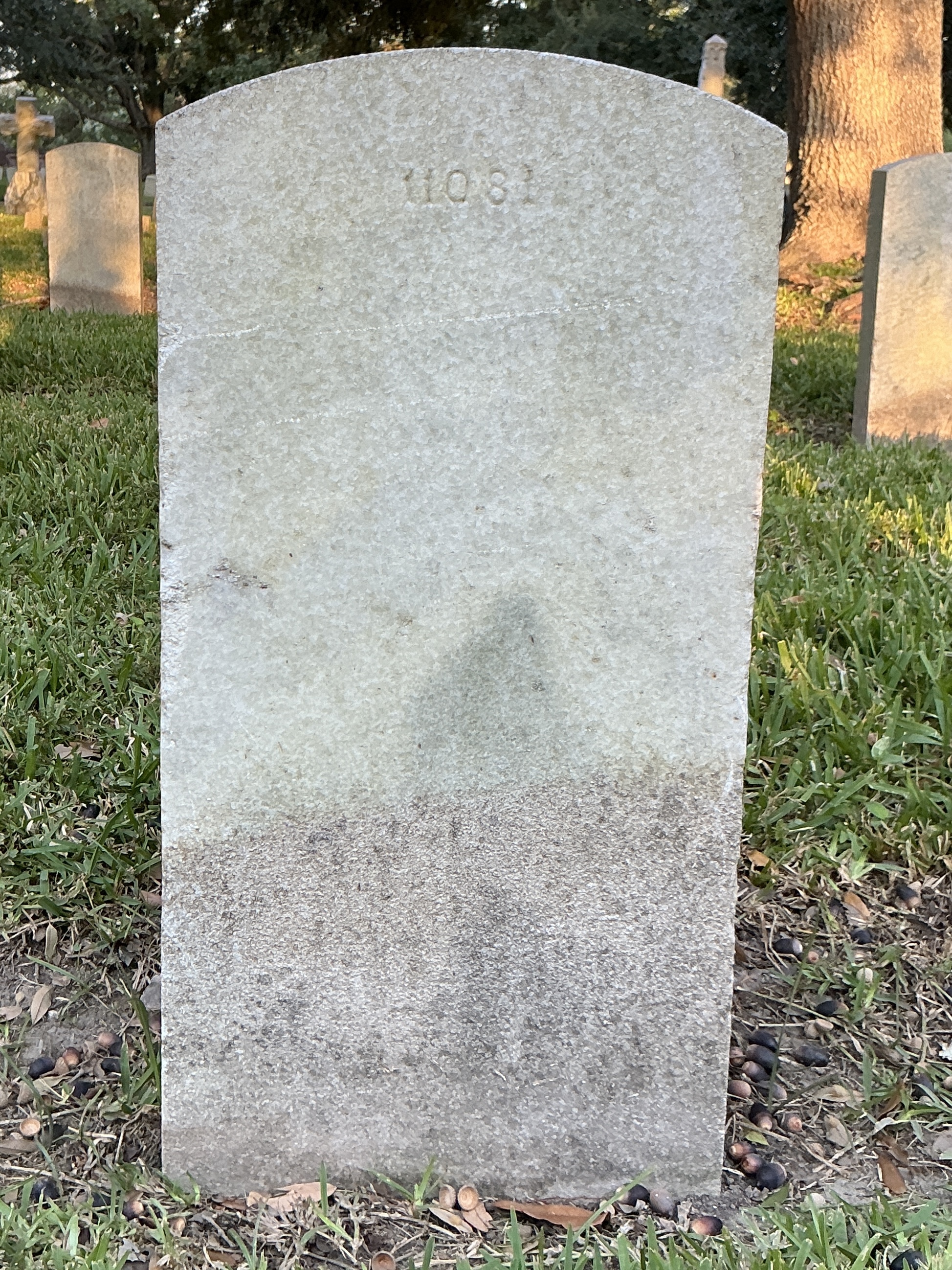 Back of upright marble headstone with flat face.