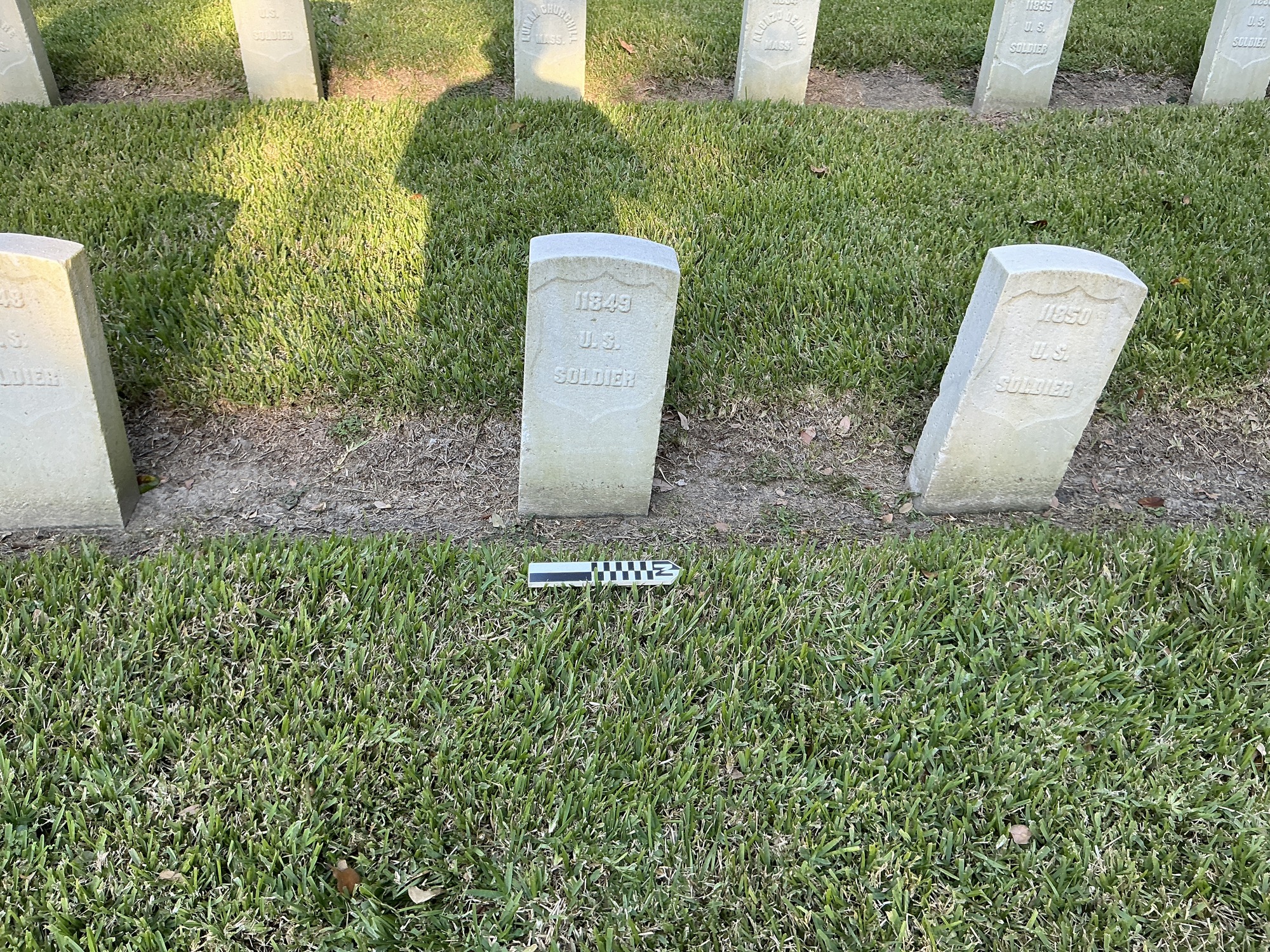 Extra image of historic upright marble headstone with recessed shield face.