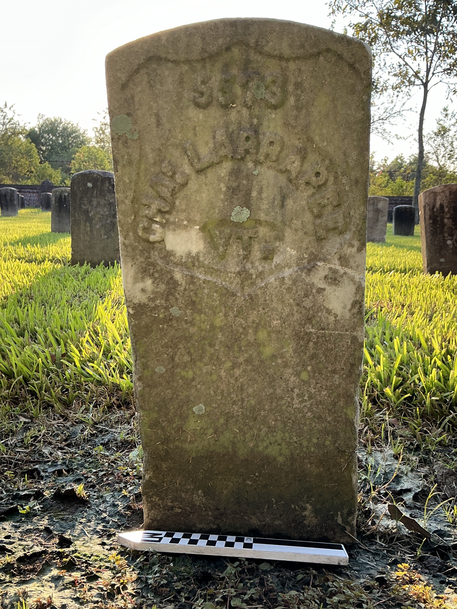 Extra image of historic upright marble headstone with recessed shield with recessed lettering face.