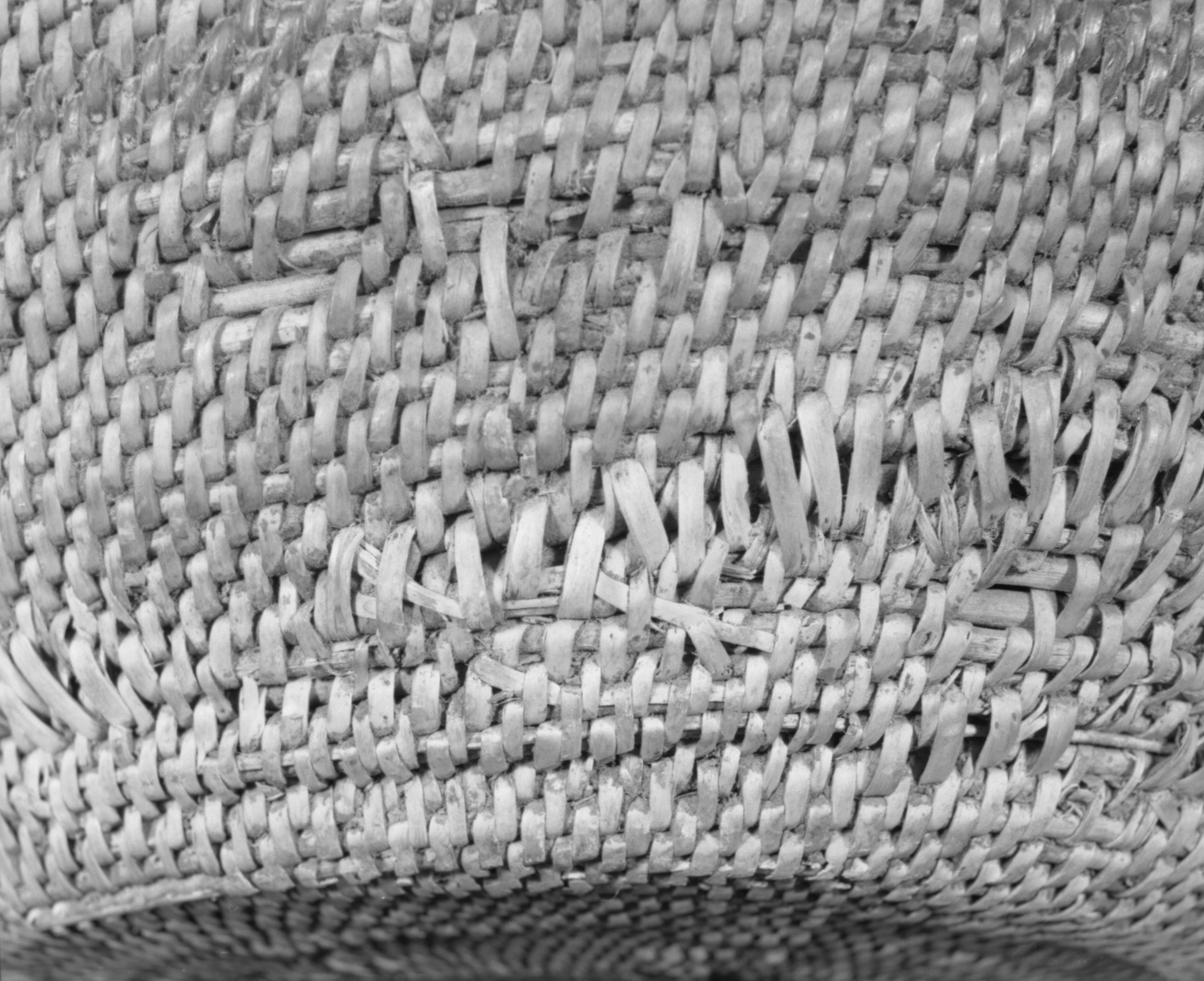 Private Collection. Object: Miwok basket. Dimensions: 18 x 10". Materials: Redbud and split willow shoots in original basket. Repairs in split maple shoots. Technology: Original basket is single rod, interlocking stitch, leftward coil direction. Repair begun on base of old basket and worked toward center until center 3 1/4", when clockspring start was stitched in to fill remainder two rows of coiling with two sewing strands at the same time, one redbud & one willow, near upper edge of original basket. Collection History: Collected by owner's mother. Murphys 1915. Photographed by Michael Dixon. Catalogued by Craig Bates and Barbara Beroza. Yosemite Collections, National Park Service.