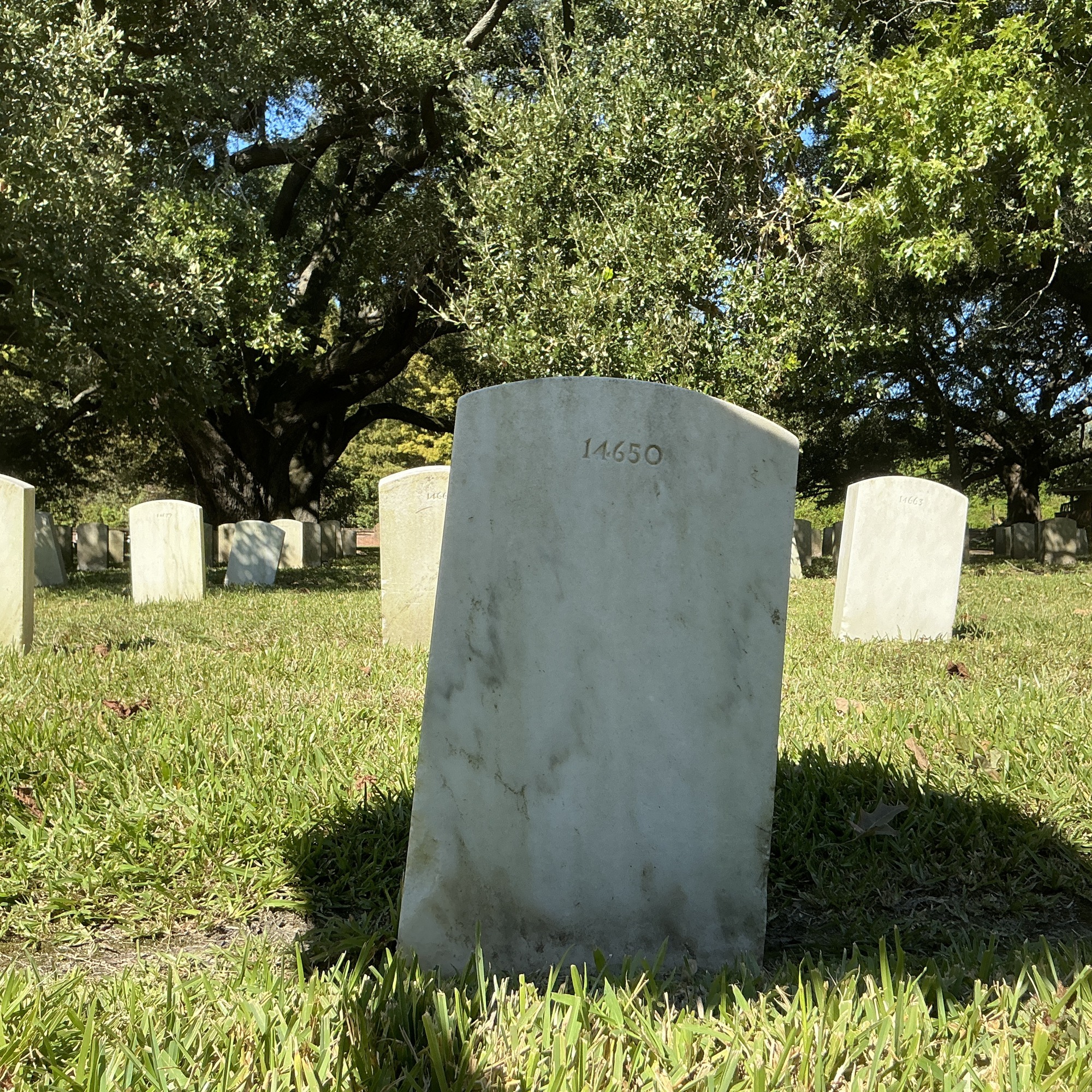 Back of upright marble headstone with flat face.