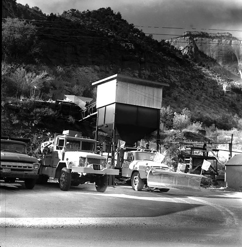 Dry sand hopper at Oak Creek Maintenance utility area - Incentive Award suggestion. Trucks, plow, and equipment in foreground, West Temple in background.