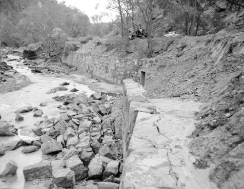 Flood damage to rock wall on Virgin River, a quarter mile south of Court of Patriarchs. Record of damage or defective workmanship.