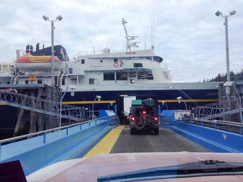 Driving onto the AMHS ferry, a jeep with bike and kayak sits in line in front of the photographer's car, ready to load onto the ferry below the main deck.
