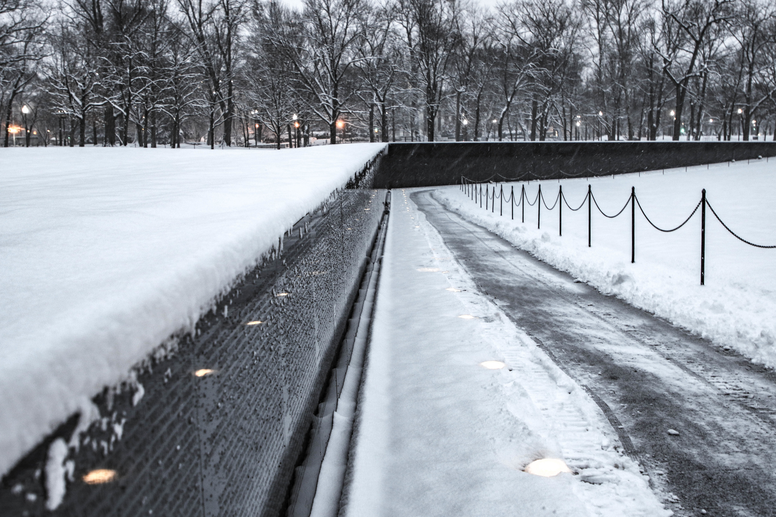 Vietnam Veterans Memorial wall and sidewalk covered with snow