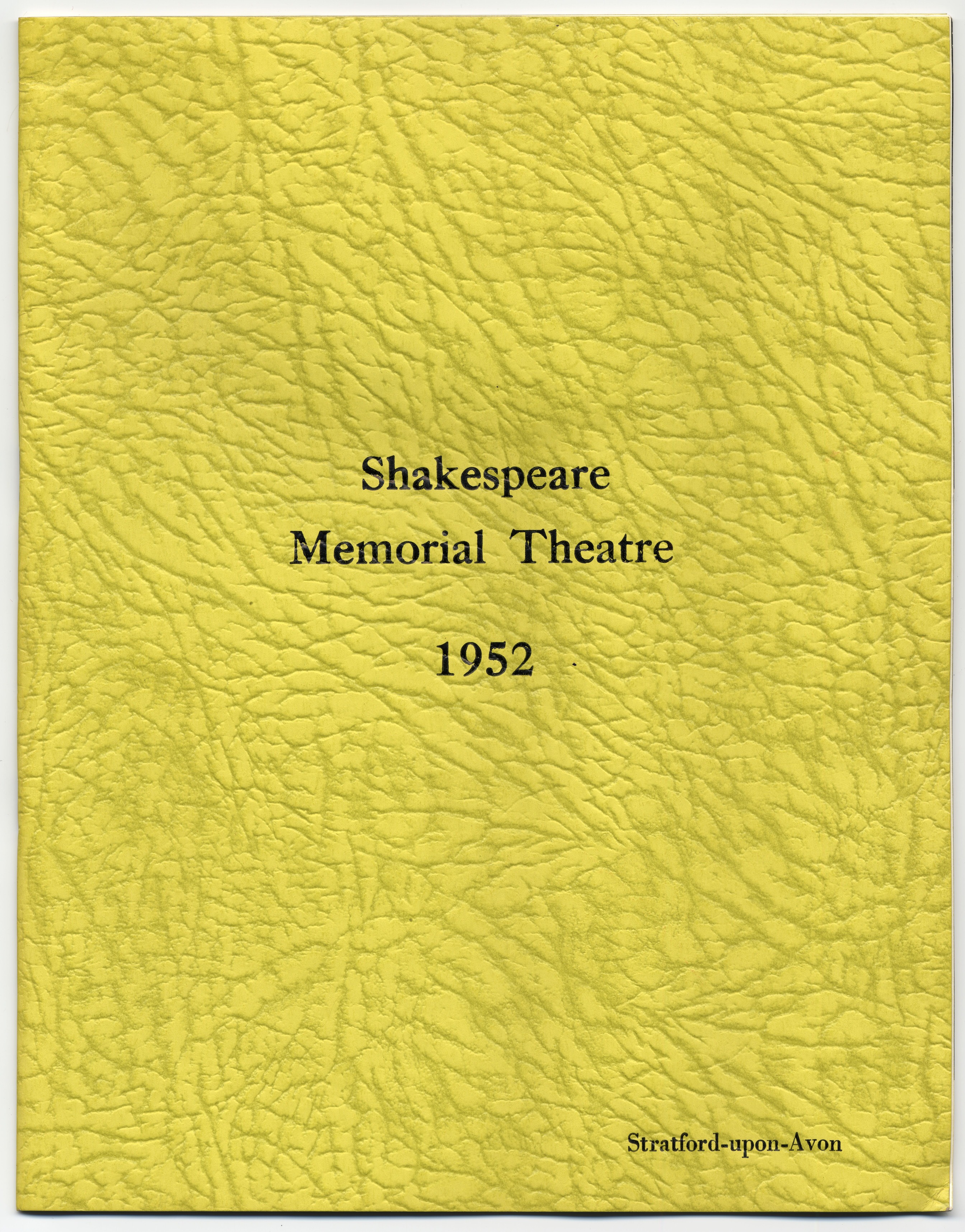 A large, yellow program with photos and information about the actors.