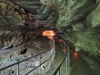 A trail lined with handrails leads deeper into the cave. 