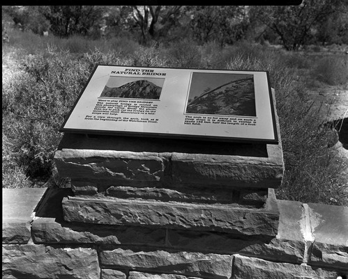 The bridge interpretive sign on east patio at Visitor Center.
