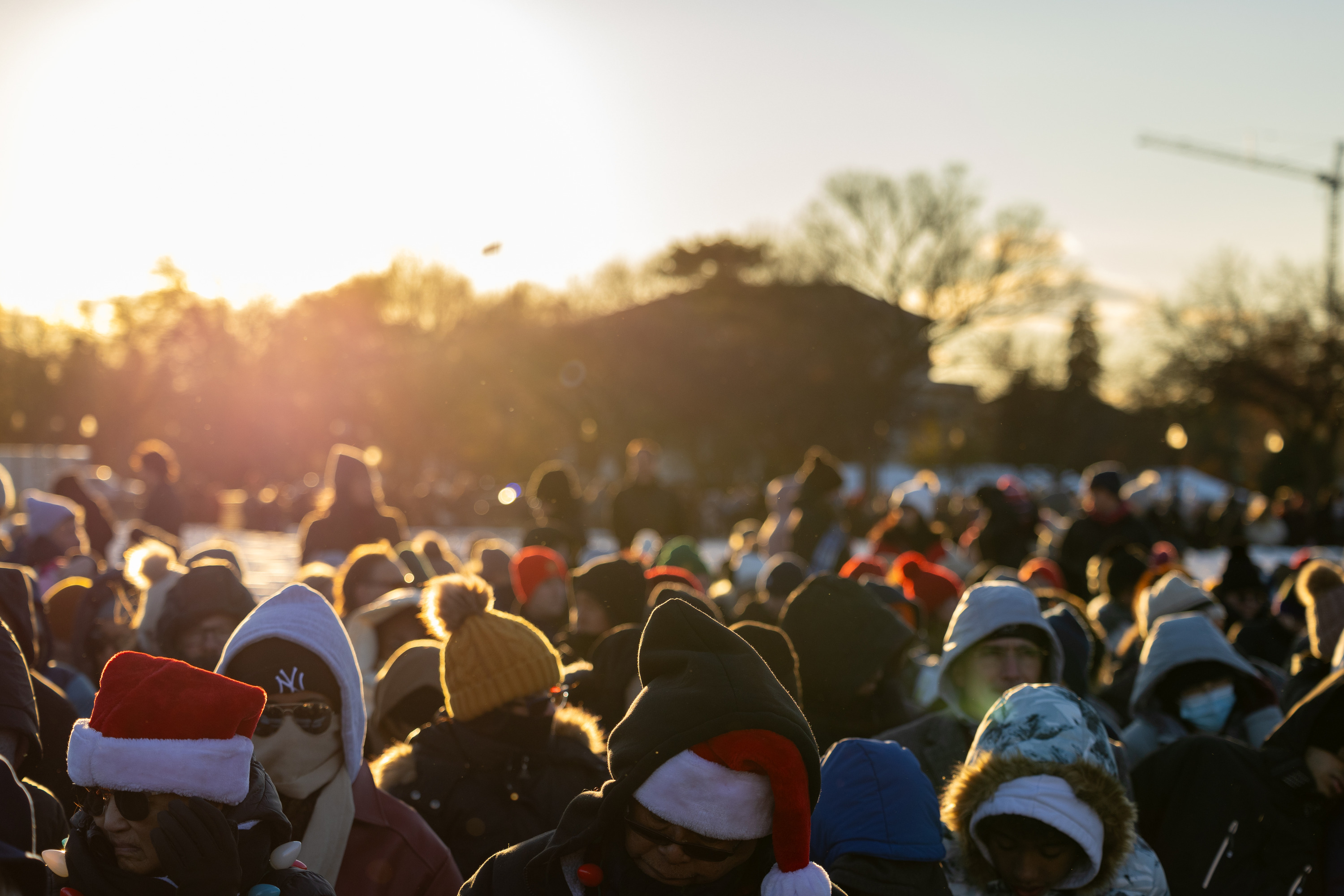 A crowd wearing winter clothing sits in their seats