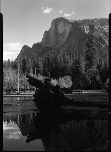 Howitzer of 30th F. A. on Camp Curry parking area. Half Dome in the distance.