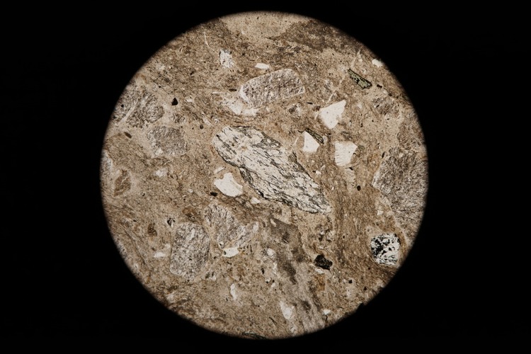 Circular microscopic image of rock structure.