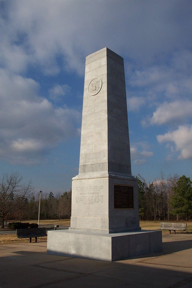 Tall, gray obelisk of the 1932 US Monument. The materials of the monument are slowly being degraded by time and acid rain. Caption follows. 