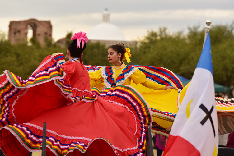 Traditional Mexican folklórico dancers in front of mission church