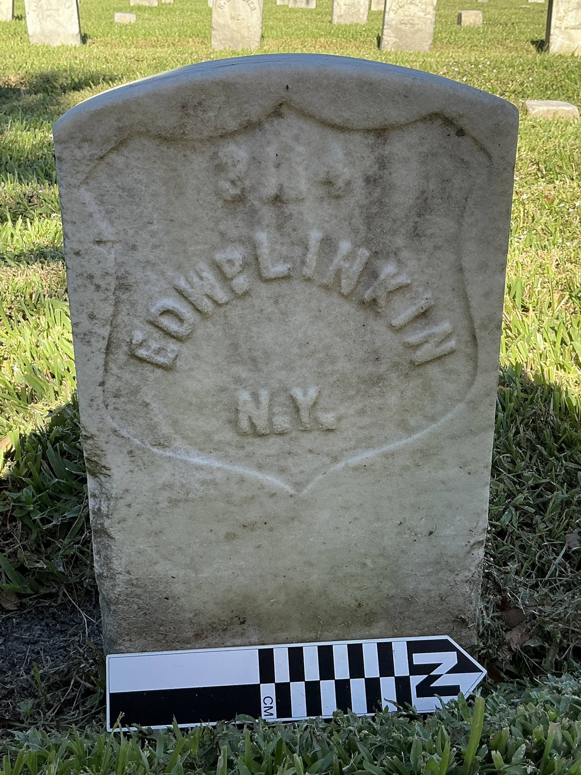 Extra image of historic upright marble headstone with recessed shield face.