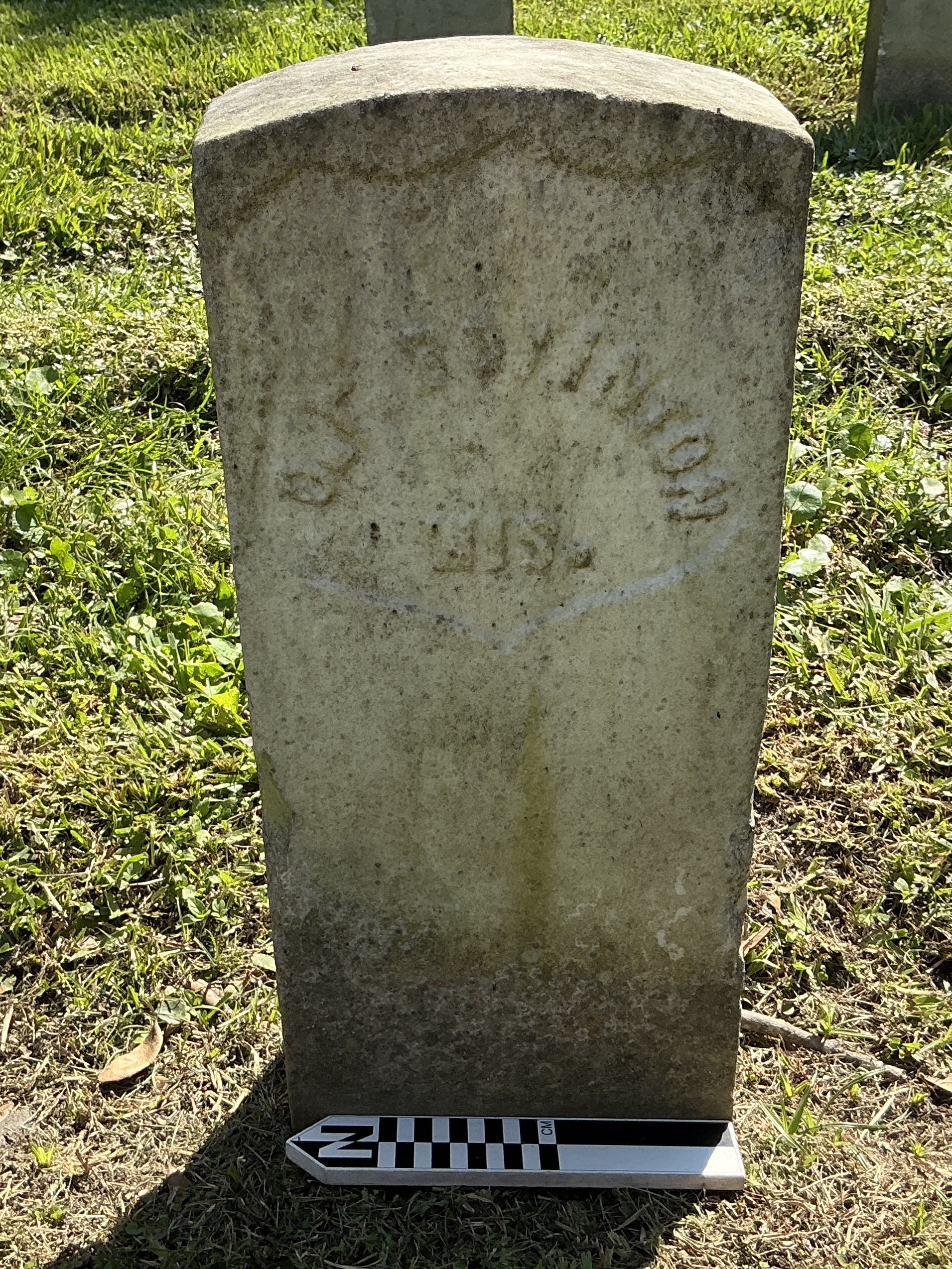 Extra image of historic upright marble headstone with recessed shield face.