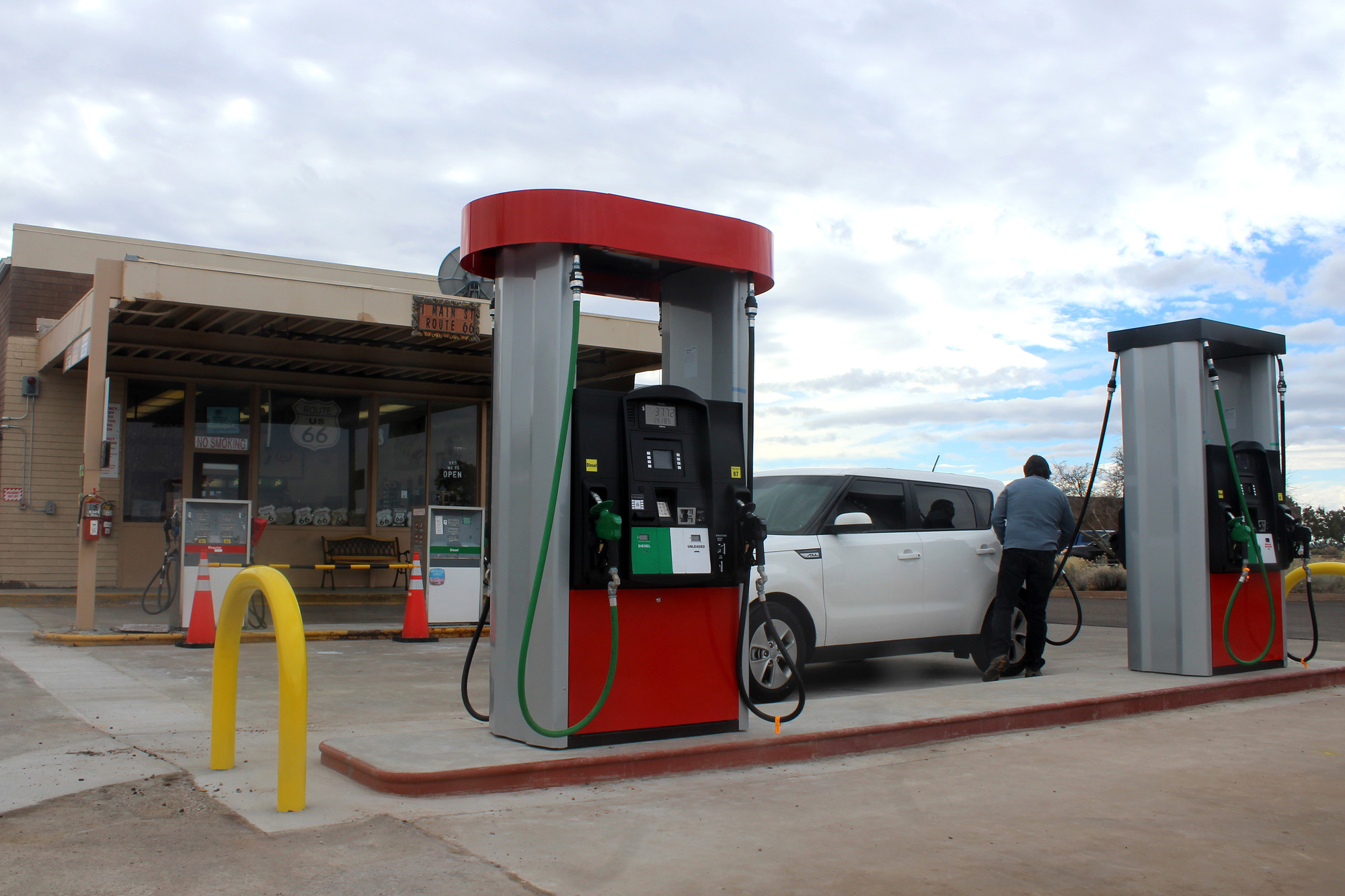 The modern gas pumps stand in front of the preserved pumps at the Painted Desert Community Complex PDCC Gas Station.