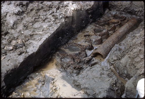 Lots of mud.  a hole with original logs visible.