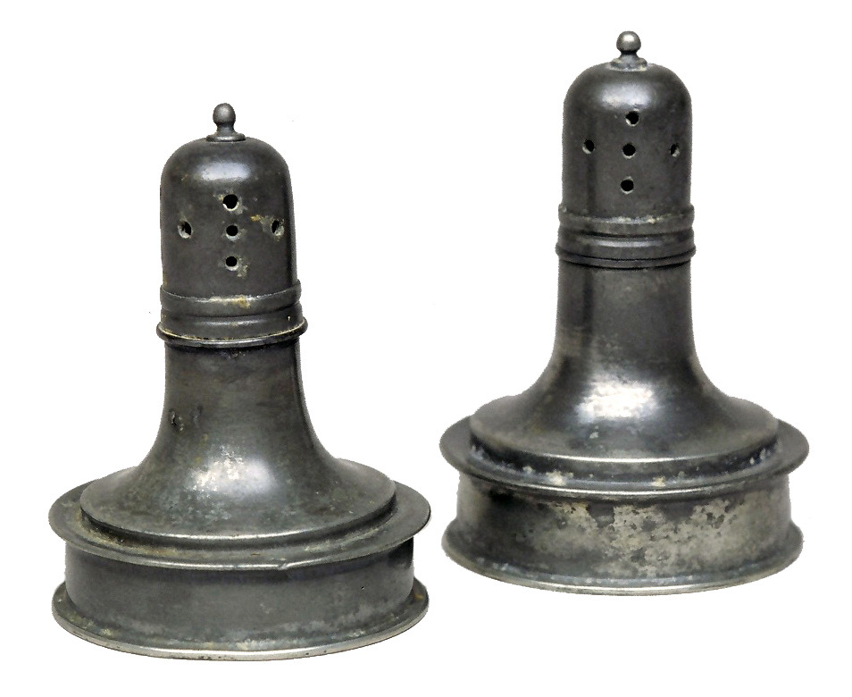 Pewter caster with round base and slim, long neck with pierced tops.