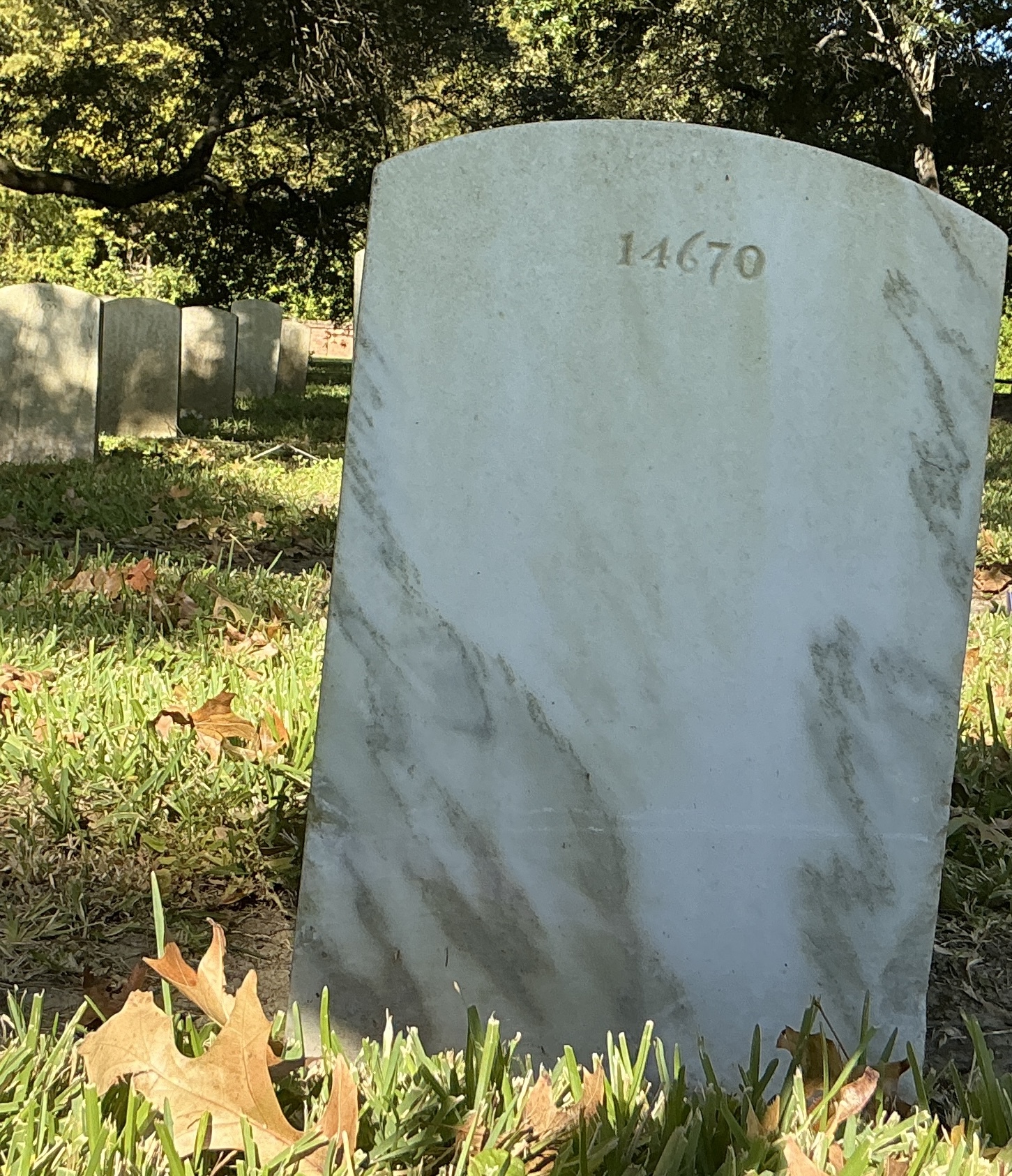 Back of upright marble headstone with flat face.