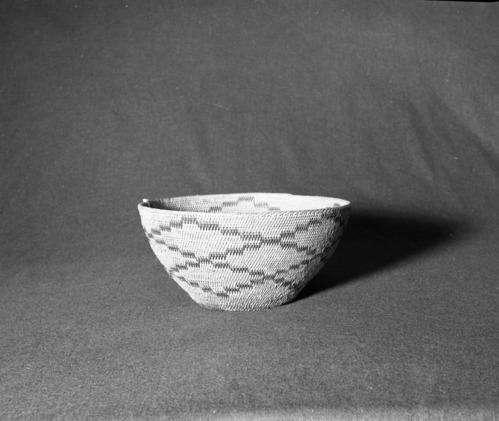 Marie Rozier Collection, Catalog No. 70. Object: Miwok cooking basket. Dimensions: 11 x 5 1/4". Materials: Split redbud shoots. Technology: Leftward coil direction; single rod; fag ends trimmed on work face; moving ends trimmed on interior; bottom rotted out as result of stone boiling. Collection History: Acquired from Mary Long, who acquired it in Tuolumne County. Photographed by Michael Dixon in December 1982. Catalogued by Craig Bates and Barbara Beroza. Yosemite Collections, National Park Service.