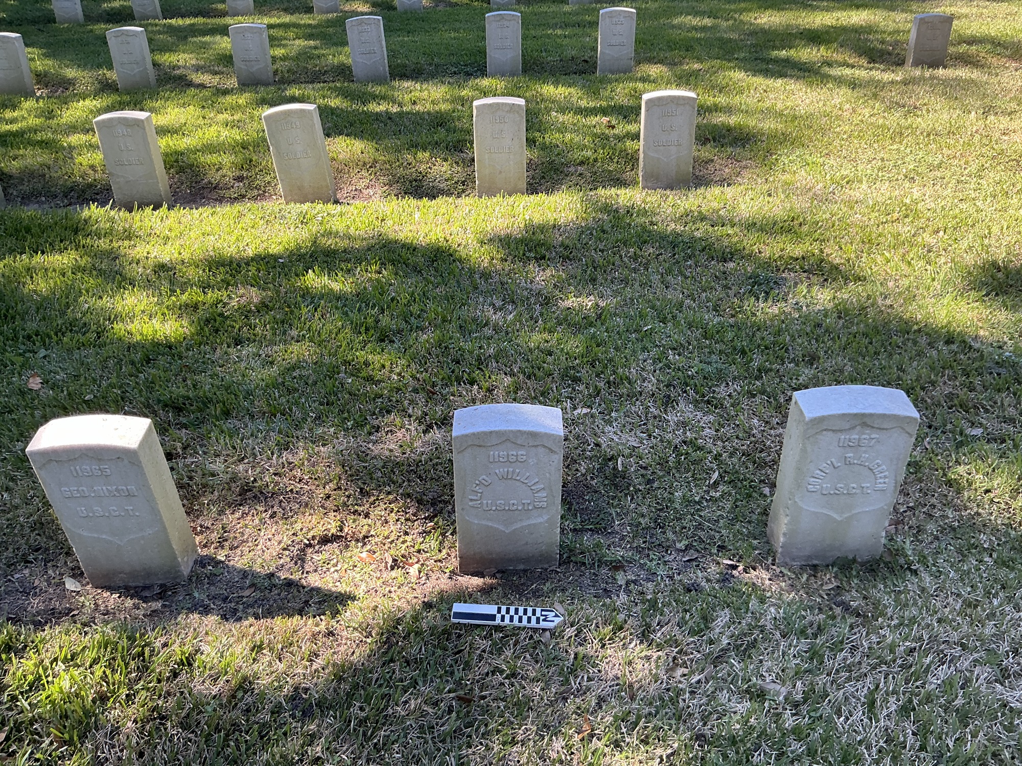 Extra image of historic upright marble headstone with recessed shield face.